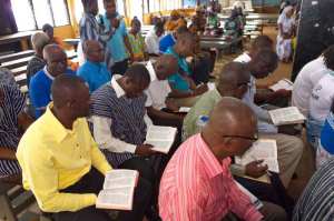 Ghanaian men consult their Bibles